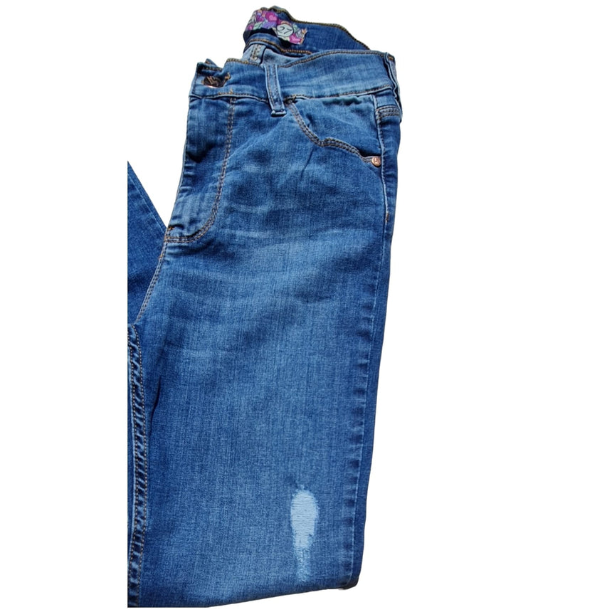 Skinny tiro alto con dobladillo y roturas